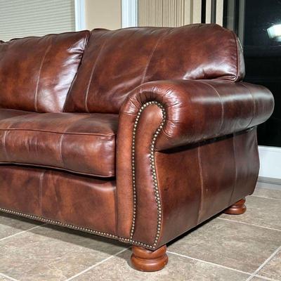 THOMASVILLE LEATHER SECTIONAL SOFA  |
In nearly new condition, brown leather L-shaped couch in 3 sections with scrolled arms, brass...