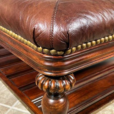 THOMASVILLE LEATHER COFFEE TABLE  |
Brown leather padded top with brass tacks, on carved wood legs with a lower open shelf - l. 40 x w....