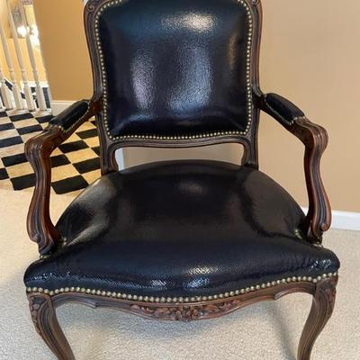 French Provincial Black Leather Arm Chair with tack decorations and carved wooden body details 