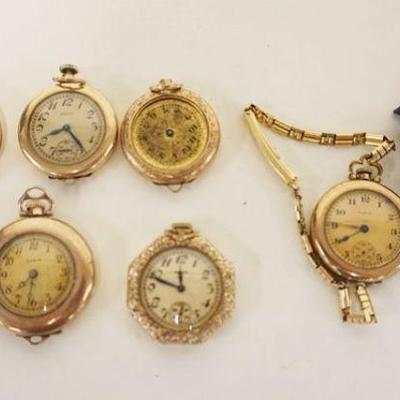 1078	LOT F 8 SMALL APPROXIMATELY 1 1/4 IN POCKET & WRISTWATCHES W/20 YEAR CASES, ALL AS FOUND
