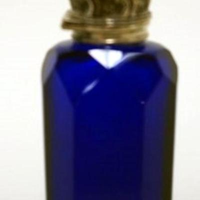 1012	COBALT BLUE GLASS CUT & POLISHED BOTTLE W/ORNATE VICTORIAN METAL HINGED LID, APPROXIMATELY 3 1/2 IN HIGH
