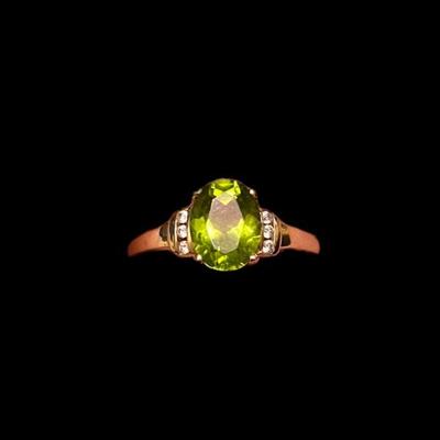 Oval Peridot In 10K Yellow Gold Setting With Three Diamonds On Each Side