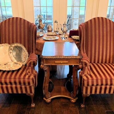 Classic wing chairs separated by a lift top game table