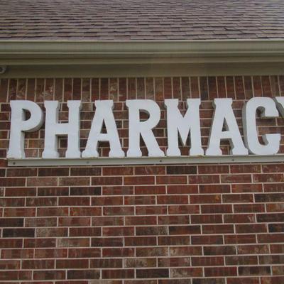 METAL PHARMACY SIGN 95 X 21 MUST BRING TOOLS AND LADDER TO REMOVE