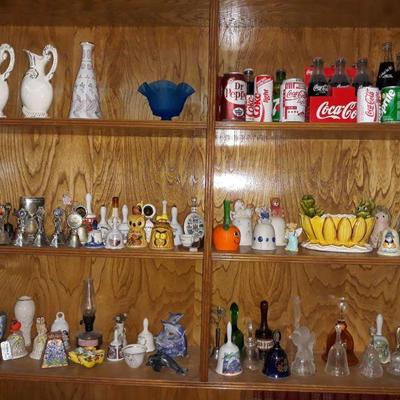 bell collection and small assorted Coca Cola bottles/cans.