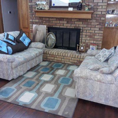 two matching loveseats and two matching area rugs