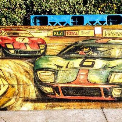 Large hand-painted wooden Le Mans race scene.