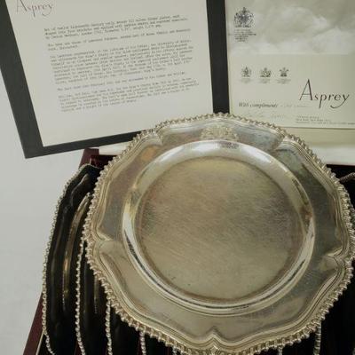 Set of 12 Eighteenth Century early George III sterling silver dinner plates with original storage case. (See description card for further...