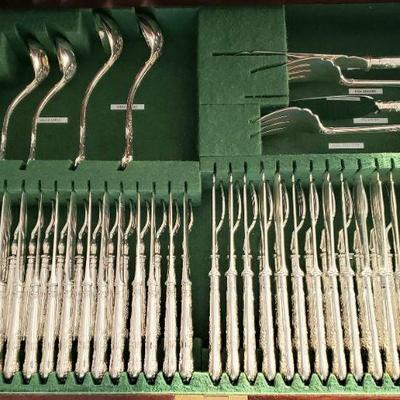 Asprey (England) QUEENS pattern hand forged sterling silver flatware set with floor standing flatware cabinet chest. Set is adorned with...