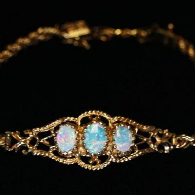 1014	14K YELLOW GOLD ROPE BRACELET W/ THREE OVAL CABOCHON CUT GENUINE OPALS. TOTAL WEIGHT INCLUDING STONES 7.25 DWTS 
