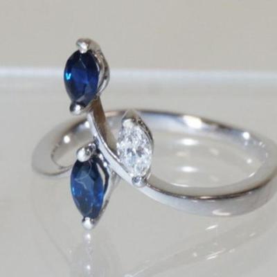 1079	BEAUTIFUL 18K WHITE GOLD RING W/ ONE MARQUISE SHAPED DIAMOND WEIGHING APP. 0.12 CARATS, & TWO MARQUISE SHAPED GENUINE BLUE SAPHIRES....