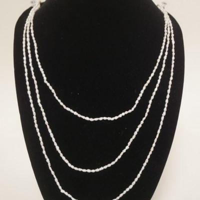 1068	GROUP OF THREE SINGLE STRAND CULTURED FRESHWATER PEARL NECKLACES EACH NECKLACE IS APP. 35 IN LONG 
