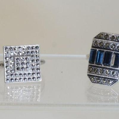 1083	TWO STERLING SILVER RINGS BOTH W/ MARCASITE ONE W/ FAUX SAPHIRE. COMBINED WEIGHT 0.354 TROY OUNCES.
