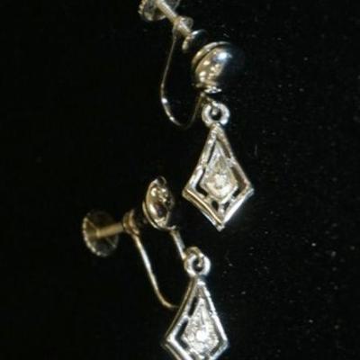 1053	PAIR OF 14K WHITE GOLD EARRINGS (NON PIERCED) W/ TWO ROUND DIAMONDS, WEIGHT APP. 0.02 CARATS. 1.90 DWT
