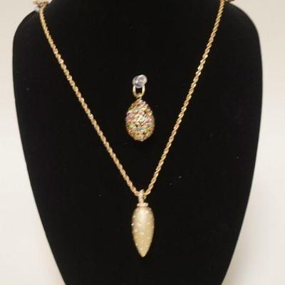 1045	COSTUME JEWELRY LOT CONTAINING TWO EGG SHAPED PENDANTS ONE IS ON A GOLD TONE CHAIN APP. 32 IN L 
