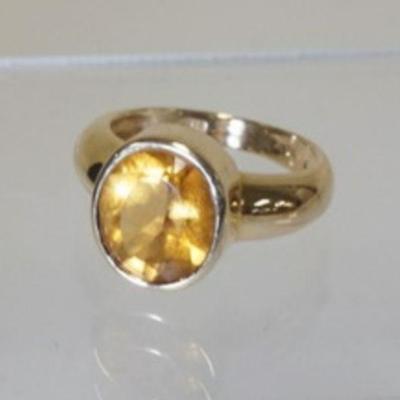 1058	14K YELLOW GOLD RING CONTAINING A GENUINE OVAL CUT CITRINE. TOTAL WEIGHT INCLUDING STONES IS 3.5 DWT. RING SIZE APP. 7
