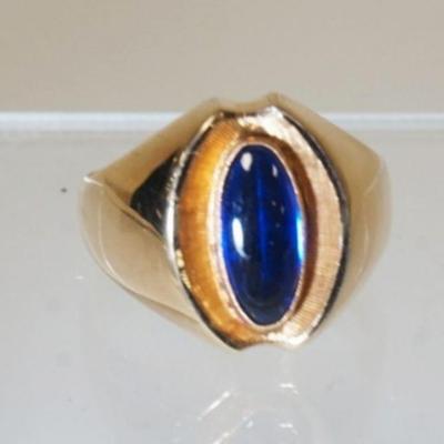 1071	18K HOLLOW GOLD RING W/ ONE FAUX BLUE STONE WEIGHT INCLUDING STONES 3.70 DWT. RING SIZE APP 9 1/4
