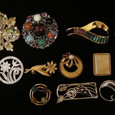 1075	LOT OF 12 COSTUME BROOCH PINS, LOT INCLUDES SAL, MICHEL GOLAN, A & J. TWO ARE MARKED GOLD FILLED, AND ONE SILVER TONE PIN HAS...