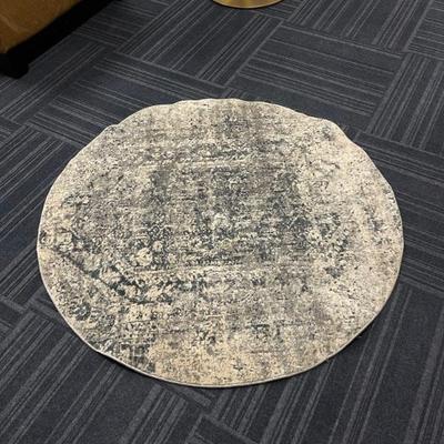 4 feet in Diameter area rug, blue grey color.  
Beautiful piece.
$50.00