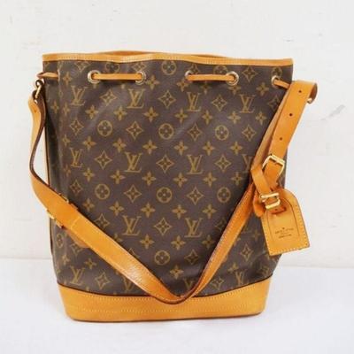1004	LOUIS VUITTON MARKED BUCKET BAG. SOME STAINING ON BOTTOM. UNKOWN IF AUTHENTIC. APPROXIMATELY 16 IN L X 14 IN H X 7 IN
