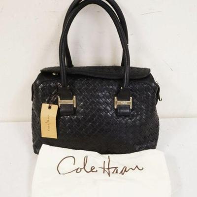 1034	COLE HAAN BLACK LEATHER BASKET WEAVE BAG WITH DUST COVER, NEW WITH TAGS. APPROXIMATELY 12 IN L X 8 IN H X 5 IN
