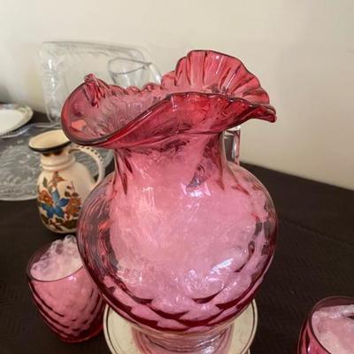 Vintage Cranberry pitcher with glasses.