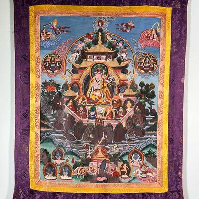 THANGKA PAINTING  |  Tibetan style Thangka painting on cloth showing many figures in a landscape, with gold, yellow, and purple...