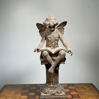 SEATED ANGEL SCULPTURE  |  Showing a fairy or angel reading on a pedestal, heavy, possibly cement - w. 9 x h. 20 in.