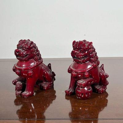 PAIR FOO DOG FIGURES  |  Foo dogs or foo lions, dark red, possibly resin or lacquered wood - l. 4 x h. 4.5 in.