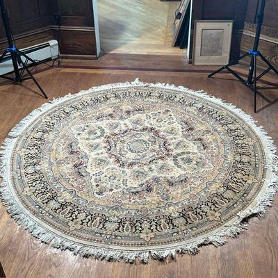 ROUND HAND KNOTTED RUG  |  Round rug with central medallion on a beige field, originally retailed at Bloomingdales, tag attached with...