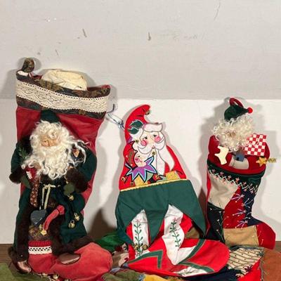 (3pc) CHRISTMAS STOCKINGS  |  Including two stockings with carved figures of Saint Nicholas (largest l. 22.5 in.)