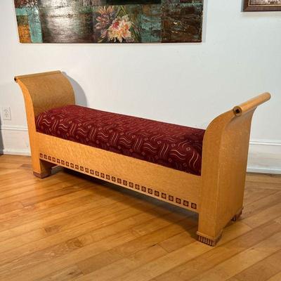 CONTEMPORARY BURL BENCH  |  Scrolled sides, the bottoms inlaid with contrasting woods, having a cushioned seat with red abstract...