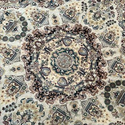 ROUND HAND KNOTTED RUG  |  Round rug with central medallion on a beige field, originally retailed at Bloomingdales, tag attached with...