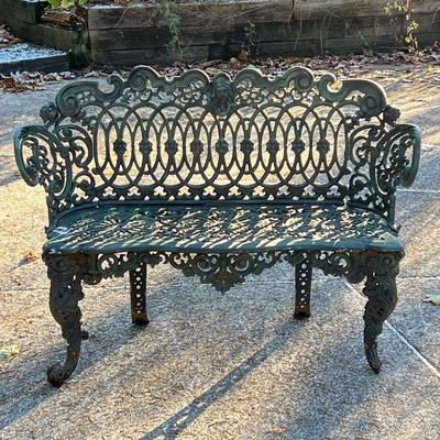 GARDEN BENCH  |  Highly decorated outdoor bench with acanthus knees, figural backrest with flowers and scrolling designs - h. 32 x l. 43...