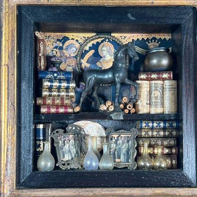 ZACARIA'S MINIATURE BOOKSHELF  |  Shadowbox frame decorated with miniature books, scrolls, a bronze horse glassware, framed prints of...