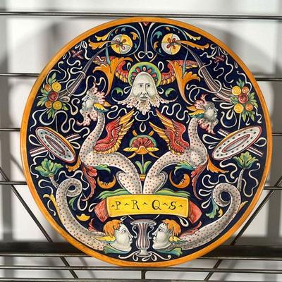 FAIENCE POTTERY CHARGER  |  "PRQS" showing mythical figures / beasts amongst mirrored scrolling foliage, no apparent markings...
