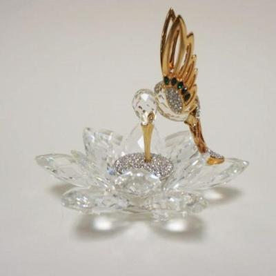 1007	SWAROVASKI CUT CRYSTAL FIGURE OF HUMMINGBIRD WITH BEAK IN FLOWER, HAVING GILT METAL ACCENTS, APPROXIMATELY 4 IN H
