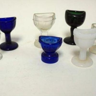 1170	GROUP OF 12 EYE WASH CUPS INCLUDING MILK, COBALT AND CARNIVAL GLASS
