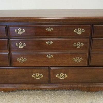 1238	CHEST OF DRAWERS WITH CHERRY FINISH, HAVING 8 DRAWERS, APPROXIMATELY 63 IN X 18 IN X 32 IN

