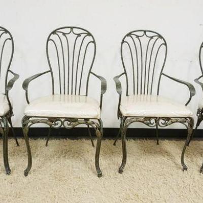 1265	SET OF 4 FANCY WROUGHT IRON PATIO OR SUN ROOM ARM CHAIRS WITH LEAF AND VINES AT BASE OF CHAIRS, OXIDIZED BRONZE FINISH
