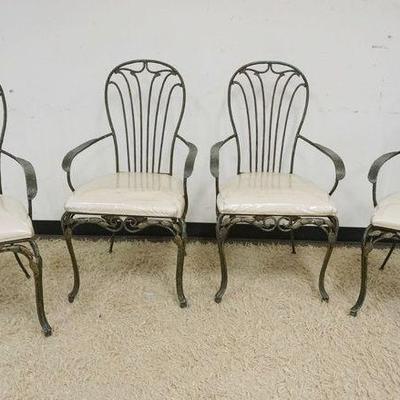 1266	SET OF 4 FANCY WROUGHT IRON PATIO OR SUN ROOM ARM CHAIRS WITH LEAF AND VINES AT BASE OF CHAIRS, OXIDIZED BRONZE FINISH
