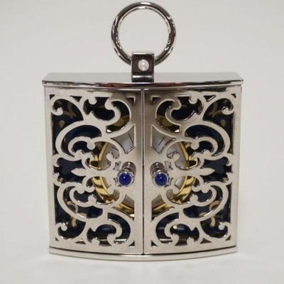 1031	MIKIMOTO CLOCK IN FRETWORK DOUBLE DOOR CASE MARKED SILVER, APPROXIMATELY 1 IN X 3 IN X 4 IN H
