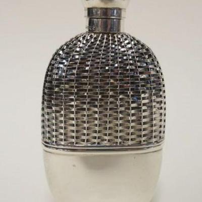 1001	SILVER FLASK WITH TOUCHMARKS ON NECK AND BASE. APPROXIMATELY 6 1/4 IN HIGH AND GLASS LINED
