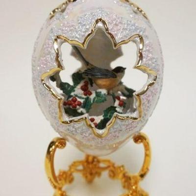 1034	FABERGE WINTER SCENE PORCELAIN EGG ON GILT FINISHED METAL STAND WITH BIRD ON SNOW COVRED BRANCH WITH RED BERRIES, APPROXIMATELY 9 IN H
