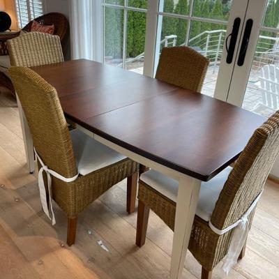 This Keystone Collection dining set features cherry wood and 2 self-storing leaves. The wicker chairs provide comfort and that coastal...