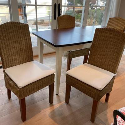 This Keystone Collection dining set features cherry wood and 2 self-storing leaves. The wicker chairs provide comfort and that coastal...