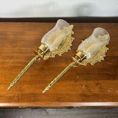 PAIR BRASS WALL SCONCES  |  
Pressed brass with glass hurricane shades, made in India - w. 6 1/2 x h. 19 in.