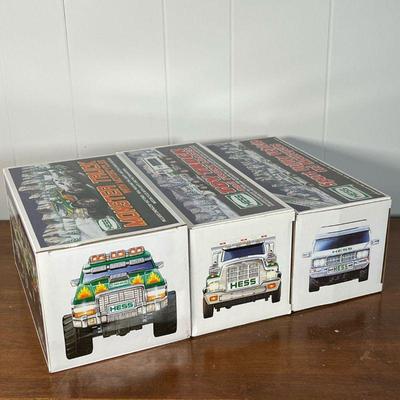 (3pc) HESS TRUCKS  |  
Including a Monster Truck with Motorcycles, Toy Truck and Front Loader, and a Sport Utility Vehicle and...