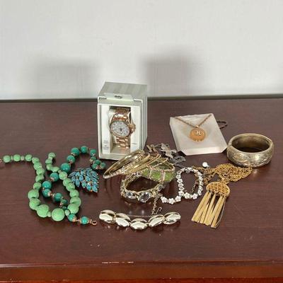 GROUP COSTUME JEWELRY  |  
Vintage costume jewelry including necklaces, a watch, a bracelet, pins, etc.