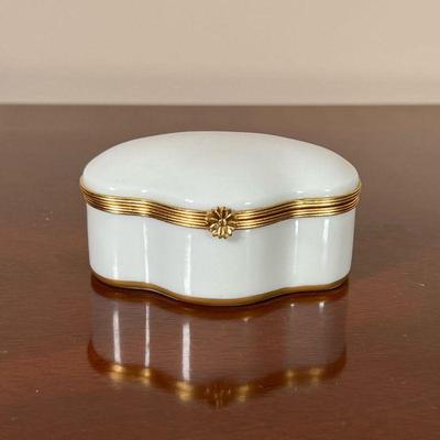 LIMOGES PORCELAIN BOX  |  
Small trinket box, white porcelain with gilt metal trim, marked on the bottom - l. 3.5 in.